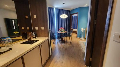 a kitchen and living room with a table in the distance at Apec Mandala Chambay Mũi Né in Ấp Thiẹn Ái