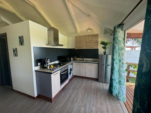 a kitchen with a sink and a stove at Moemiti in Moorea