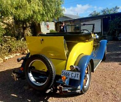 an old yellow and blue car parked in a driveway at A La Folly The Retreat in Murray Bridge