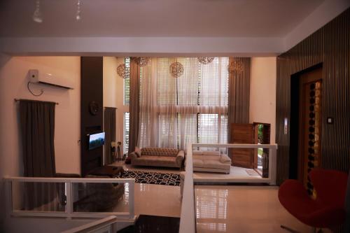 a living room with a couch and a window at Private Villa in Kollam with Pool in Kollam