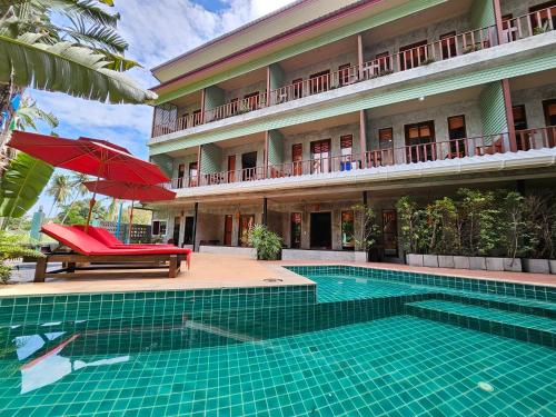 a resort with a swimming pool and a building at Araya Boutique Hotel in Thongsala