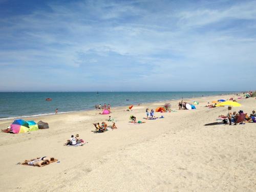 a group of people laying on a beach at ibis De Panne in De Panne
