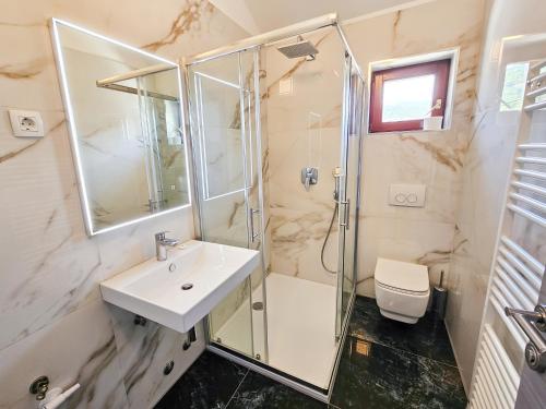 a bathroom with a sink and a shower at Rooms Tanja Lovran in Lovran