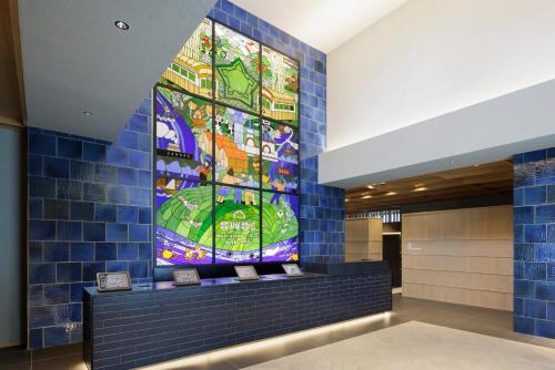 a stained glass window in the lobby of a building at OMO5 Hakodate by Hoshino Resorts in Hakodate