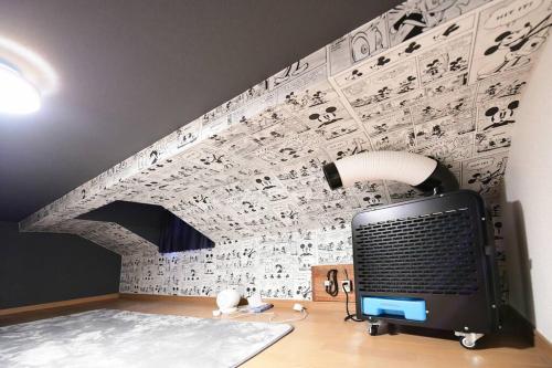 a computer on a desk with a wall covered in musical notes at Largo in Tokyo