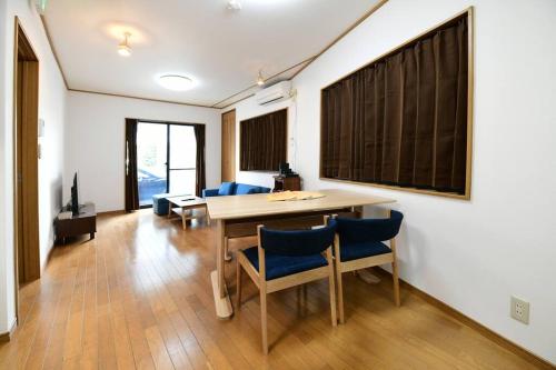 a dining room with a table and blue chairs at Largo in Tokyo