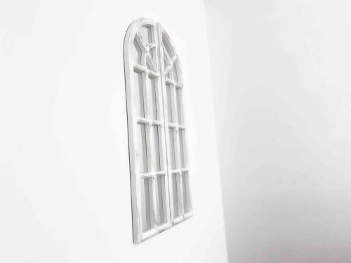 an open window in a white wall with at Palm Rest - 2BR Beachside Escape On Towradgi Beach in Towradgi