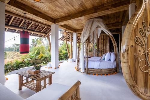 a bedroom with a bed and a wooden ceiling at Magic Hills Bali - Eco Luxury Adventure in Karangasem