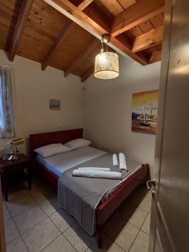 a bedroom with two beds and a chandelier at Mastiha house in Neochórion