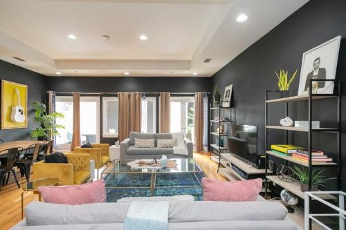 a living room with black walls and pink furniture at Grand Loft ON THEE Broadway Strip in Nashville