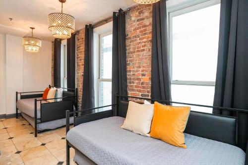 a room with two beds and a brick wall at Loft Literally on Broadway Live Music & Bars in Nashville