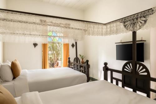 Postel nebo postele na pokoji v ubytování Silva Heritage Resort Goa