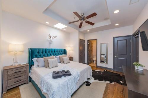 a bedroom with a large bed and a ceiling fan at Spacious Penthouse ON the Broadway Strip in Nashville
