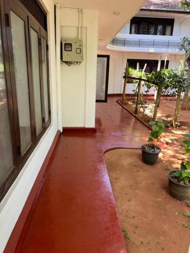 an empty hallway of a building with a red tile floor at Nallur Residence in Jaffna