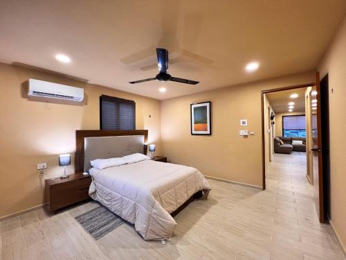 a bedroom with a bed and a ceiling fan at Depa Palenque I Cancun in Cancún