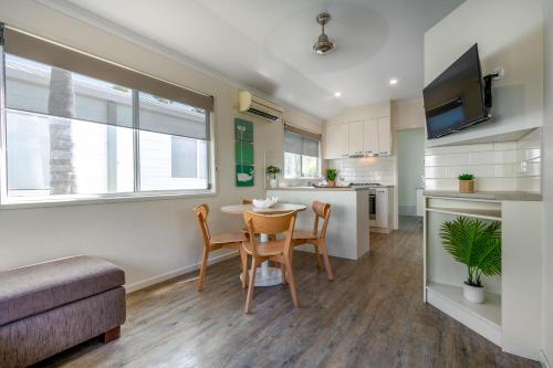 a kitchen and living room with a table and chairs at BIG4 Tasman Holiday Parks - Ballina in Lennox Head