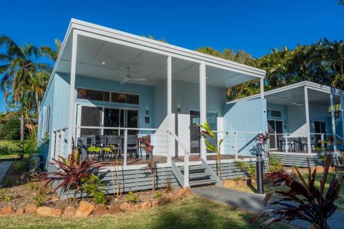 a blue house with white columns and a porch at BIG4 Tasman Holiday Parks - Ballina in Lennox Head
