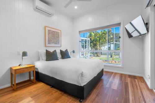 a bedroom with a large bed and a window at BIG4 Tasman Holiday Parks - Ballina in Lennox Head