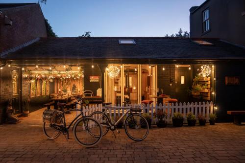 a bike parked in front of a house with lights at Garden Cottage at Old Post Office in Bardon Mill