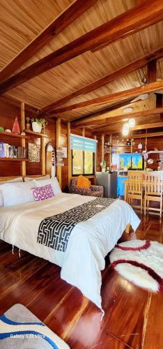 a large bedroom with two beds in a room at Chue&larry's Beachside Homestay in Libagon