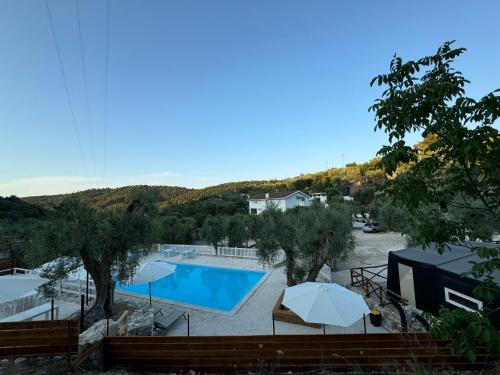 a view of a swimming pool with umbrellas at Village Valle D'Oro ApartHotel in San Menaio
