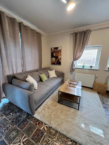 a living room with a couch and a coffee table at CentralPark Suites in Maribor
