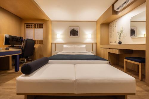 Postel nebo postele na pokoji v ubytování AanK Hotel & Spa Pyeongtaek