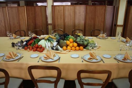 a table with a bunch of fruits and vegetables on it at Hotel Rausan in Alfajarín