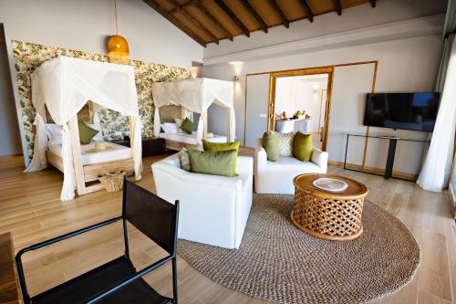 a bedroom with two beds and a living room at Bawe Island Zanzibar in Zanzibar City