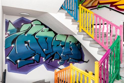 a staircase with graffiti on the wall at Rise Urban Art Hotel in Larnaka