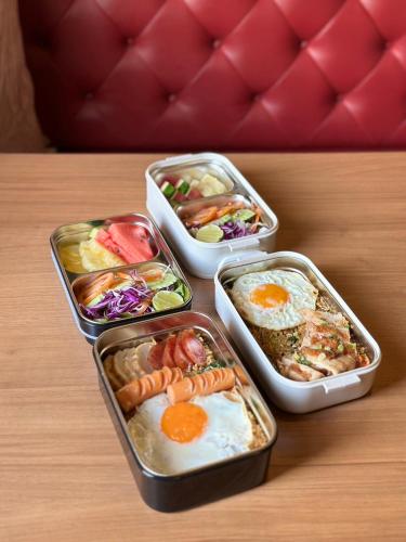 four plastic containers of food on a table at The Terminal Khon Kaen Hotel in Khon Kaen