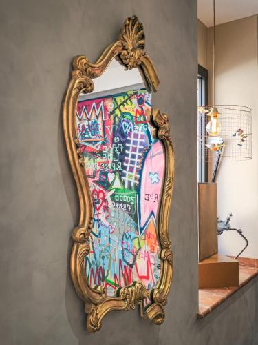a mirror on a wall with graffiti on it at Grand Hôtel Dauphiné Toulon, Boutique Hôtel & Suites in Toulon