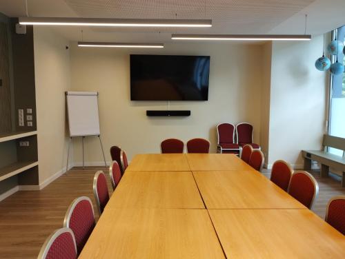 a conference room with a large wooden table and chairs at acama Hotel & Hostel Kreuzberg in Berlin