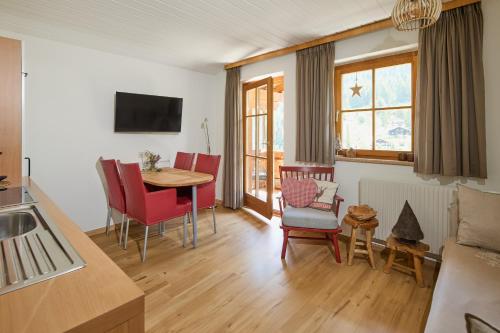 a kitchen and living room with a table and chairs at Haus Altana in Gargellen