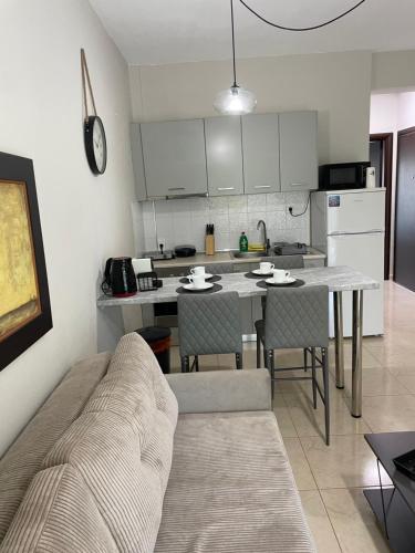 a kitchen with a table and chairs in a room at Kaza Oasis in Ofrínion