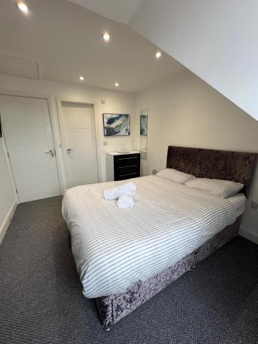 a bedroom with a bed with two towels on it at Fully ensuite room in Hull