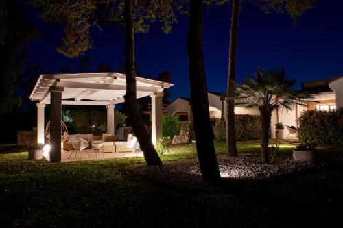 a backyard at night with a white pergola at MARISTESI in Siniscola