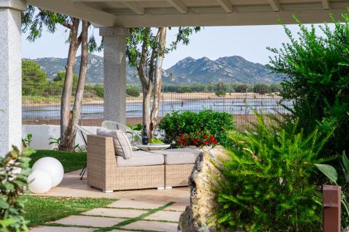 a porch with a wicker couch on a patio at MARISTESI in Siniscola