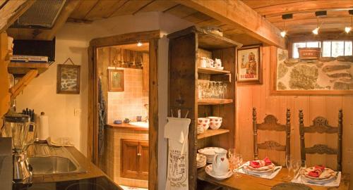 a kitchen with a counter with a sink and a refrigerator at Hôtel Les Chalets de Philippe avec Jacuzzis Privatifs in Chamonix-Mont-Blanc