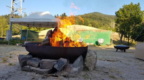 a large pot of fire in a fire pit at Wildnis- und Offroad Camp Schwarzwald in Bad Peterstal-Griesbach