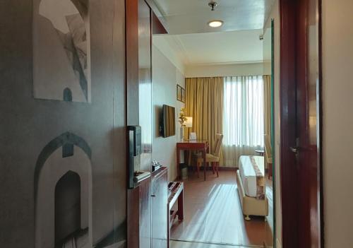 a hotel room with a room with a living room at Vesta International in Jaipur