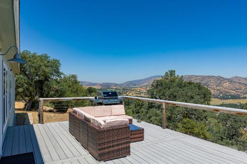 a patio with a chair and a grill on a deck at Five Points House with Amazing Views in Tehachapi