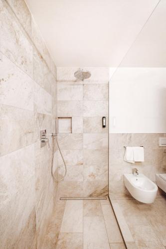 a bathroom with a shower and a sink at Hotel Plan de Gralba - das Berghotel in Selva di Val Gardena