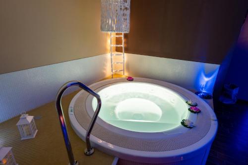 a bath tub in a room with a lamp at Zyra Garden Club in Acquaviva delle Fonti