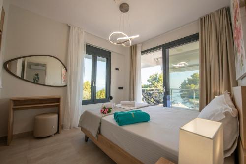 a bedroom with a large bed and a large window at Casa de Lapel Mola Kaliva in Mola Kalyva