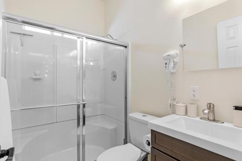 a white bathroom with a shower and a toilet at Five Points House with Amazing Views in Tehachapi