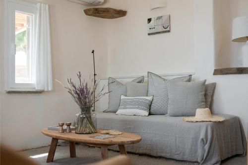 a bed with pillows and a table in a room at Morfes Luxury Apartments in Triandáros