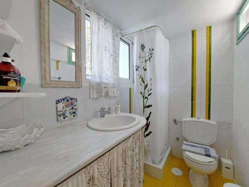 a bathroom with a sink and a toilet at Poros Pine View in Poros