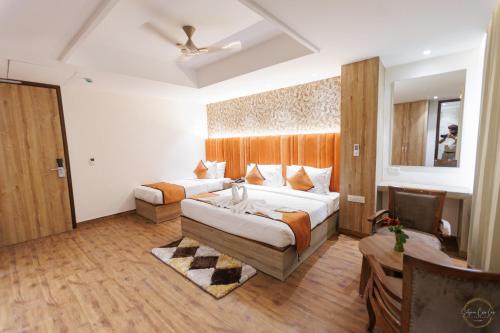 a hotel room with two beds and a table at Mannat Residency By iO Hotels Near Golden Temple in Amritsar