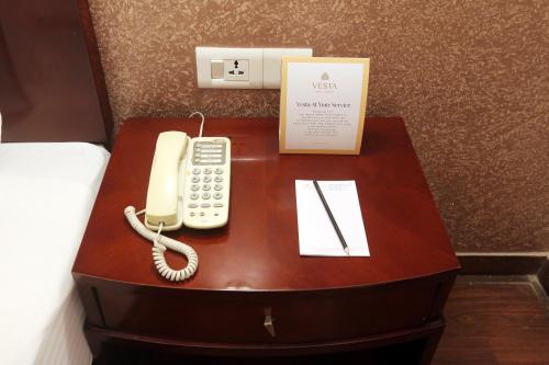 a phone on a table in a hotel room at Vesta Maurya Palace in Jaipur